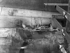 HMS HAWKE collision damage-boss plating showing temporary wedging in holes..jpg